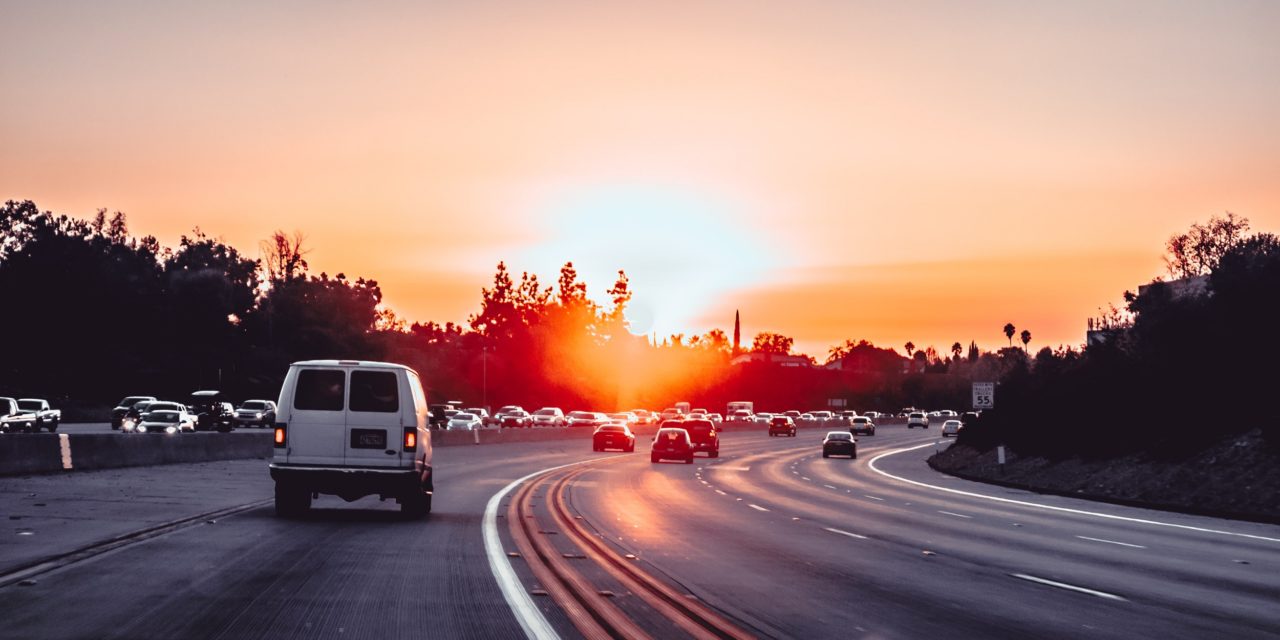 road with cars and sunset